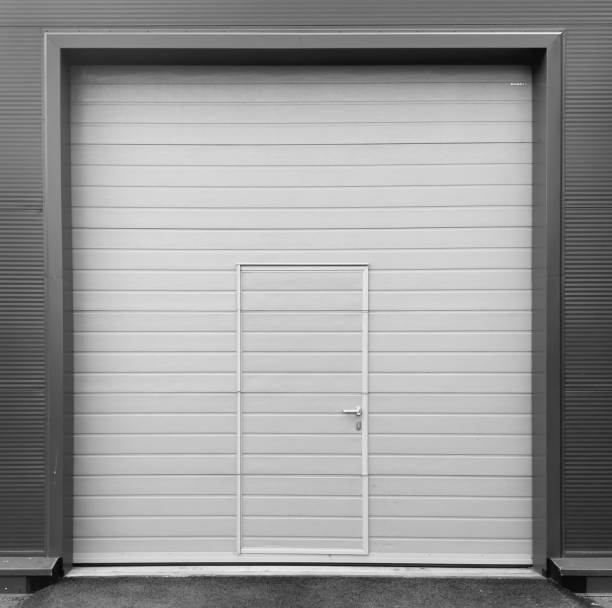istock Roller shutter gate. Metal roller garage door as background. Automatic electric roll-up garage gate. Garage with white rolling gates. 2160967650