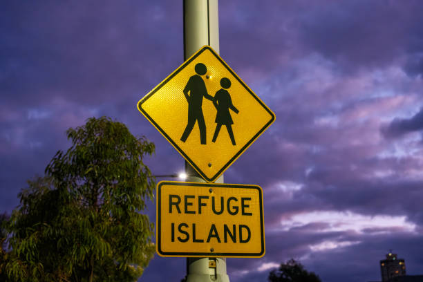 Refuge island sign with a dramatic early morning sky behind.
