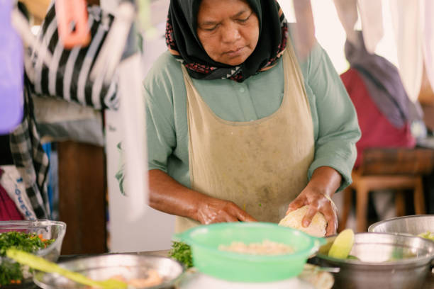 istock Real Woman in Real kitchen Preparing White Cabbage Surrounded by Crockery 2160970065
