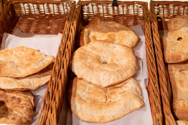fresh hot unleavened flatbreads in a woven basket in a bakery