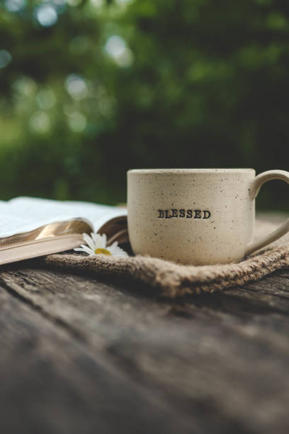 istock Cup with text BLESSED and open Bible in the garden, good morning 2160971698