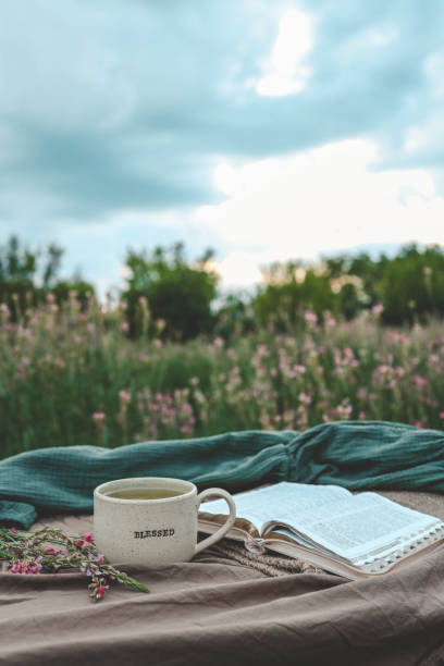 istock Cup with text BLESSED and open Bible in the garden, good morning 2160971702