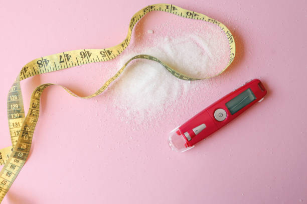 istock Sugar level measuring tool and measuring tape on table, weight loss concept 2160972593