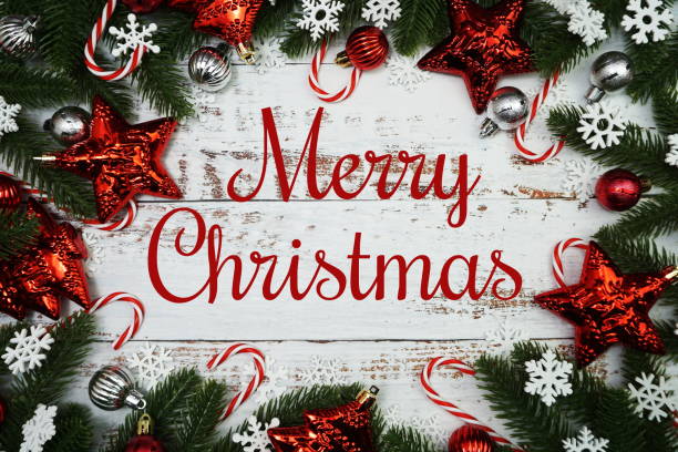 istock Merry Christmas text with fir tree branches border frame on wooden background 2160973131