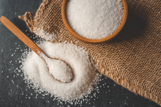 istock Wooden bowl and spoon with salt, top view 2160973640