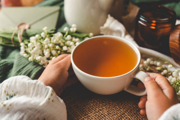 istock Cup of herbal tea in hands, spring atmosphere mood 2160974701