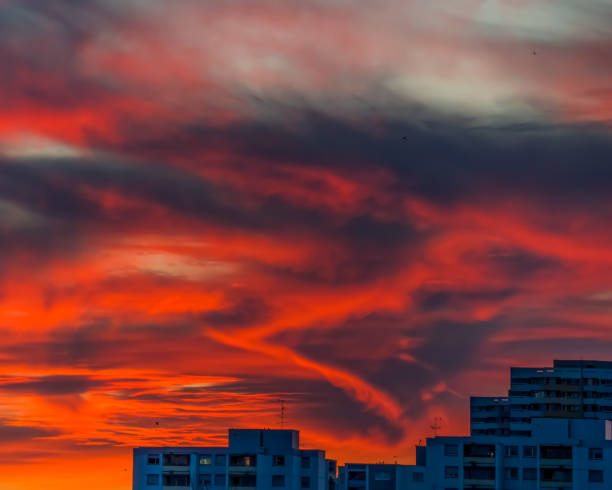 Sky etude in the evening, Burning sky at sunset over city buildings