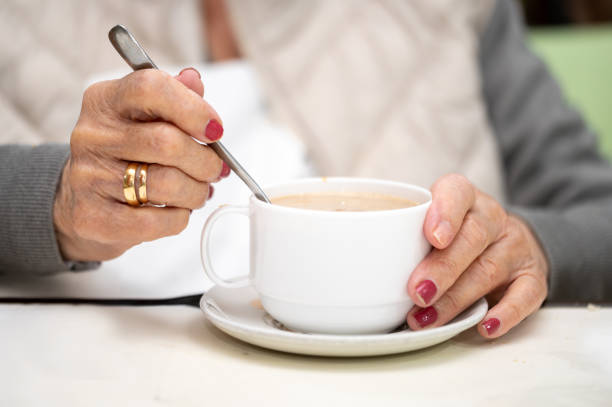 istock Close up of elderly woman enjoying breakfast. 2160977372