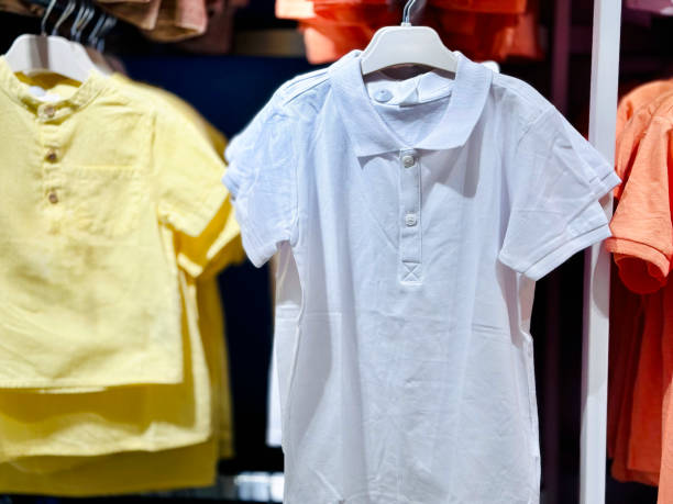istock Yellow White and Orange Polo Shirts on Hanger 2160977444