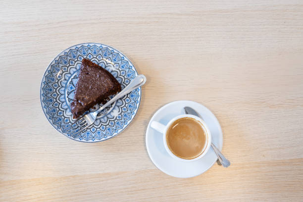 istock Slice of chocolate cake and a coffee viewed from above with copy space 2160978154