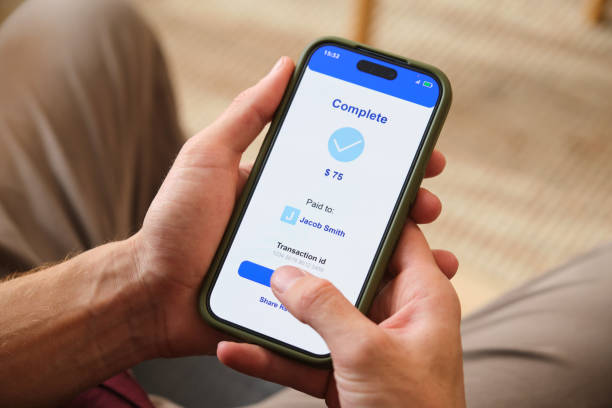 istock Hands holding smartphone with completed mobile payment and transaction id 2160982251