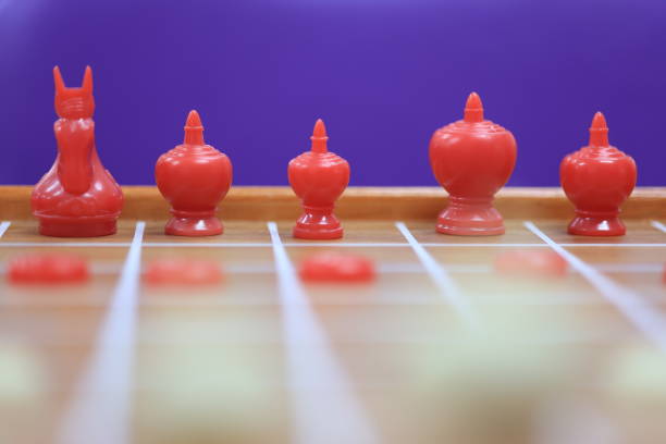 Red chess pieces on a chessboard with Purple background