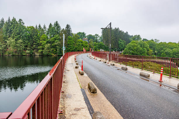 istock Empty country road passing over Robertville Dam wall along lake 2160983789