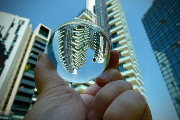 istock Hand holding crystal ball with skyscrapers background 2160984582