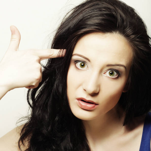 istock woman shows gesture gun with finger 2160985325