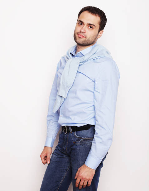 istock happy young man in blue shirt. 2160985621