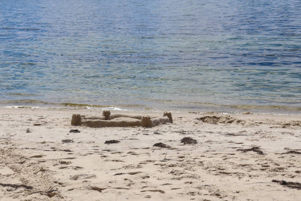 istock sand castle by the sea 2160987077