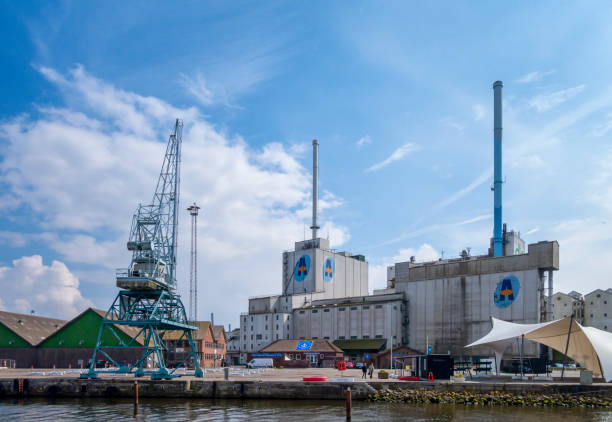 Buildings belonging to DLG Group, the largest farm supply company in Europe, next to Bassin (dock or basin) 3 in the harbour in Aarhus, eastern Jutland, Denmark. DLG (Dansk Landbrugs Grovvareselskab) is a Danish co-operative - Danish Agricultural Grocery Company - owned by Danish farmers. Also visible is a famous and very large dockyard crane, which is part of Dok8000, a commercial centre in the docks.