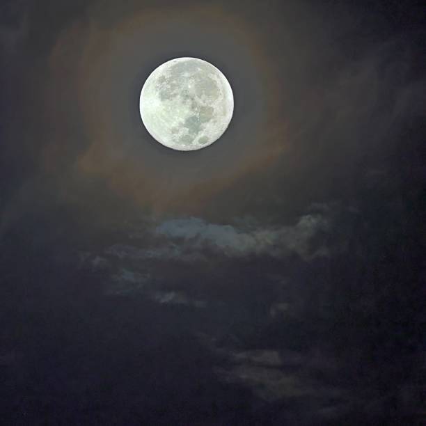 istock Blue Supermoon Shining in the Dark Night Sky with Clouds 2160987577