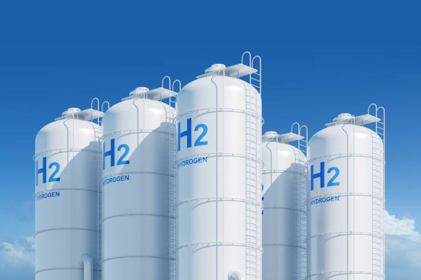 istock White hydrogen storage tanks with blue H2 labels, set against a blue sky with clouds, symbolizing clean energy. 3D Rendering 2160988199