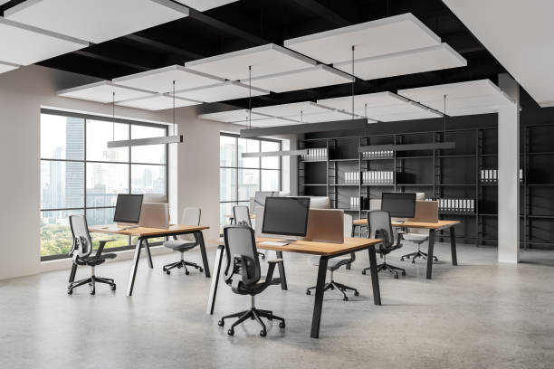 istock Modern coworking interior with pc monitors on desks, panoramic window 2160988420