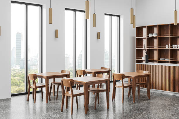 istock Minimalist cafe interior with dining table, bar counter near panoramic window 2160988551