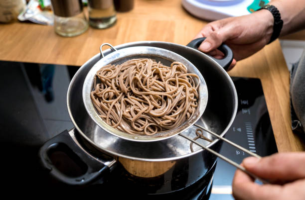 istock Chef at the kitchen preparing japanese buckwheat pasta with lentils 2160988735