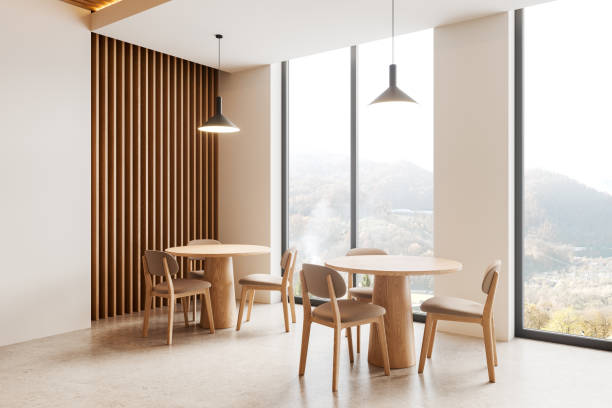 istock Beige cafe interior with chairs and tables in row, dining space near window 2160988762