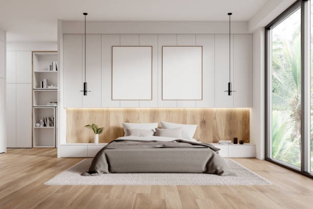 istock Stylish hotel bedroom interior with bed and shelf, window. Mockup frames 2160989036