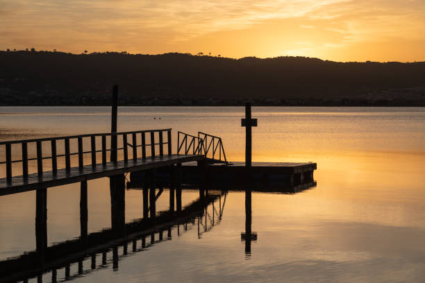 istock Wooden pier on lagoon at sunrise 2160989058