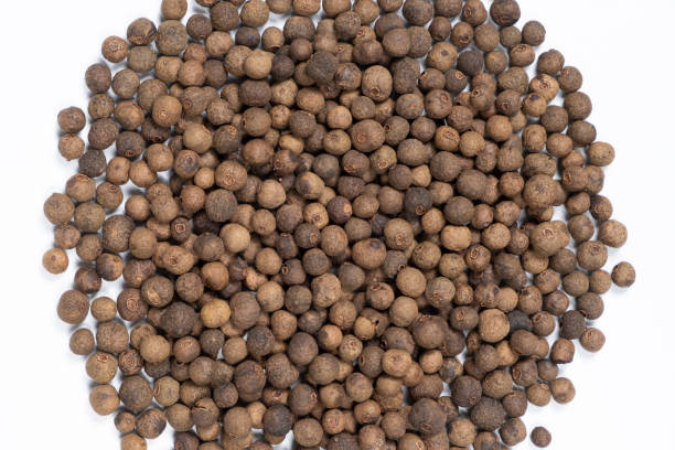istock Black peppercorns close-up top view on white background. 2160990196