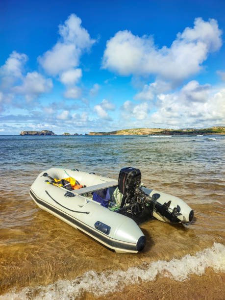 istock Coastal Escape - Inflatable Boat on Sandy Shore with Sea View 2160990769