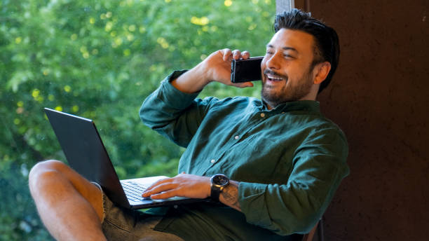 istock A middle-aged handsome businessman working with his laptop outside the office environment 2160991798