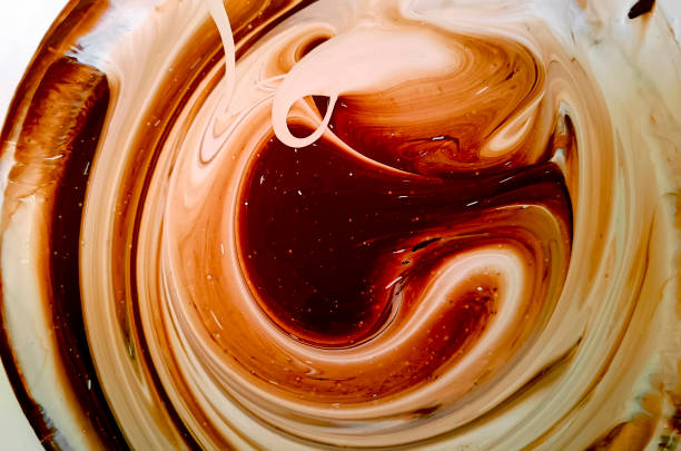 istock Beautiful abstraction of liquid paints in slow blending flow mixing together gently 2160993464