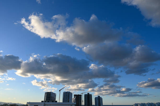 blue sky and clouds over the construction site of a residential complex