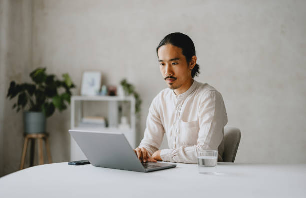 istock Focused Professional Man Working On Laptop In Modern Office 2160994949