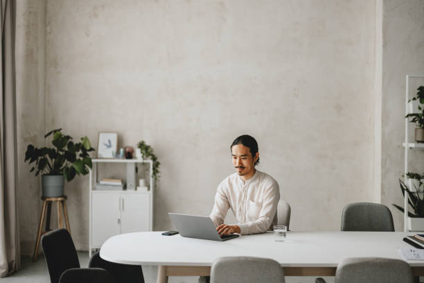 istock Man Working at Laptop in Modern Office Space 2160994952