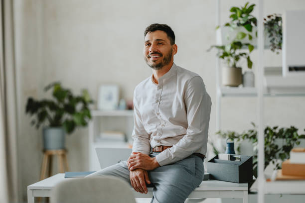 istock Smiling Businessman Sitting In Modern Office Environment 2160995113
