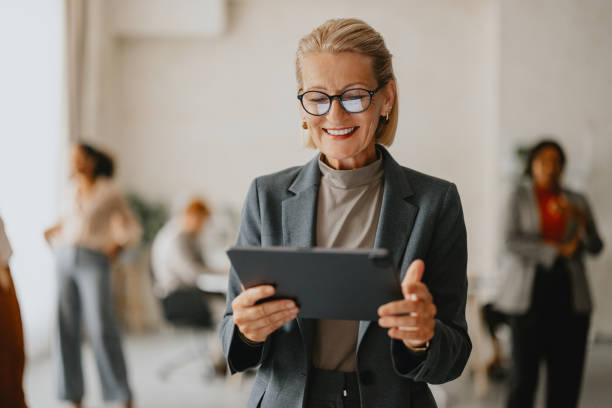 istock Senior Businesswoman Using Tablet in Modern Office Environment 2160995809