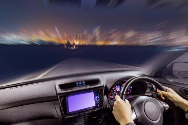 istock Image of a car driving on a road at dusk 2160996182