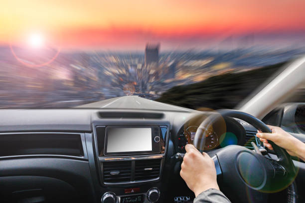 istock Image of a car driving on a road at dusk 2160996371