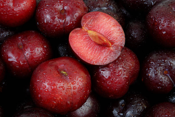 Plums fruits with water drops as background. Many ripe plums fruits with water drops as background. plum stock pictures, royalty-free photos & images