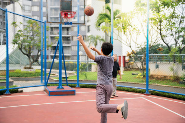 istock Father Teaching Son How to Play Basketball 2161000172