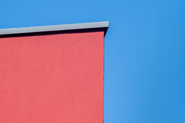 orange painted house wall in front of a blue sky