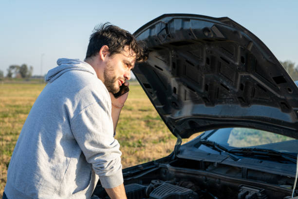 istock Young man calling mechanical assistance by phone 2161003096