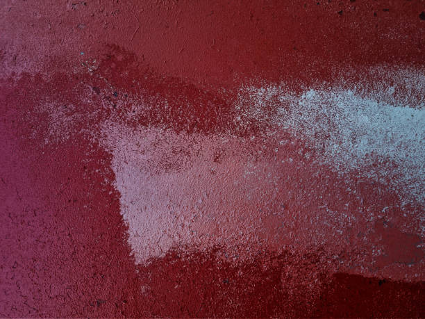 the word Revolution is scratched into a red wall