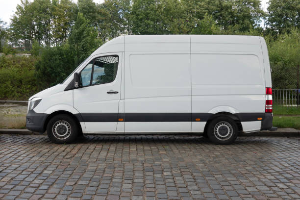 istock White Delivery Van Parked on Cobblestone Street 2161005173