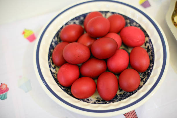 Egg dye in red color place on ceramic plates. Lunar birthday celebration concept