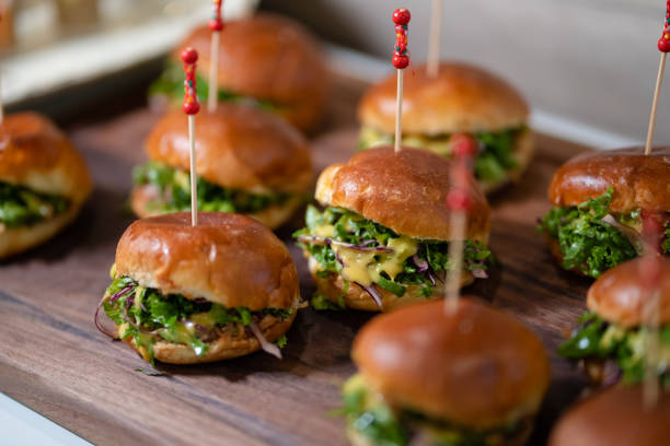 Close up mini hamburgers at cocktail party.