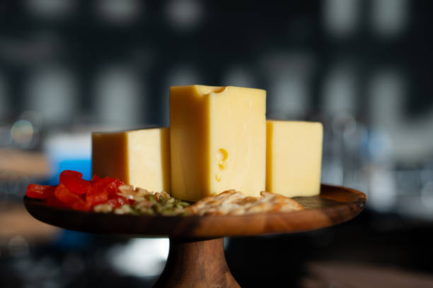 Cheese cubes placed on a high wooden tray.